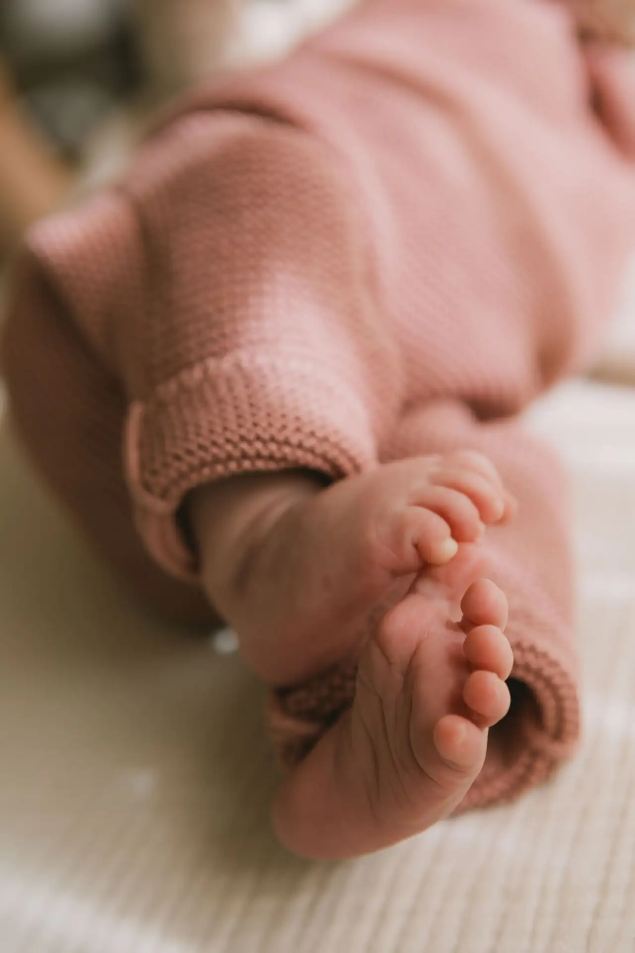 A baby's feet in soft knitted clothes